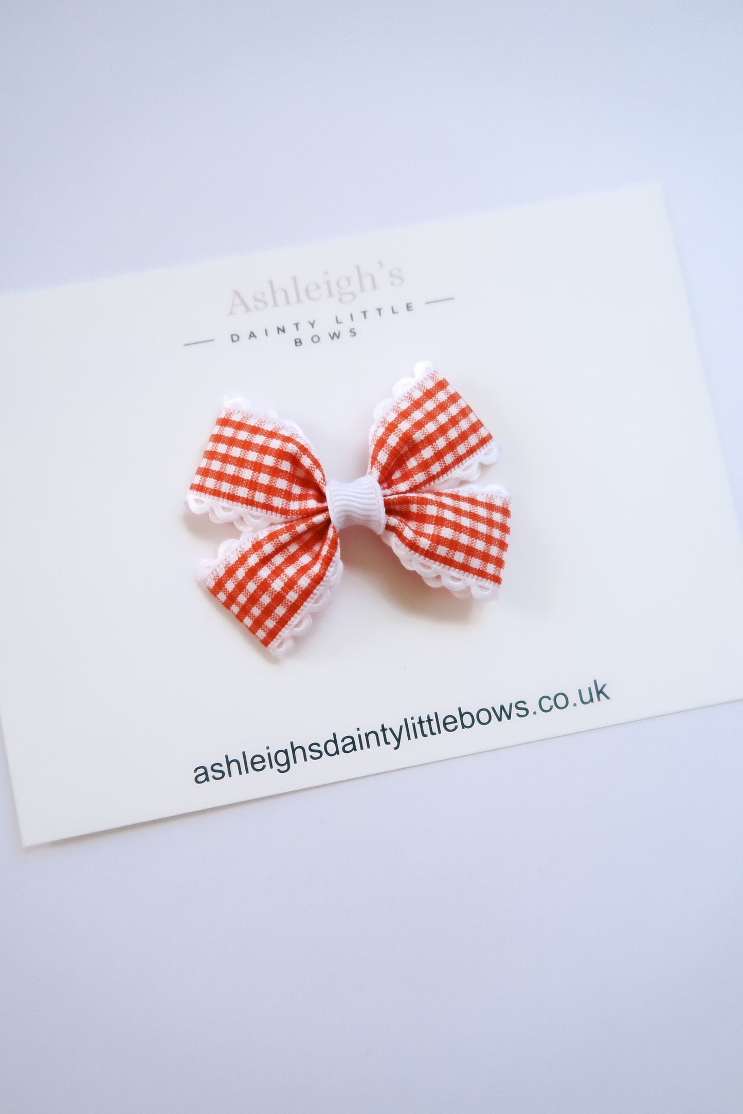 Dainty orange flutter bow