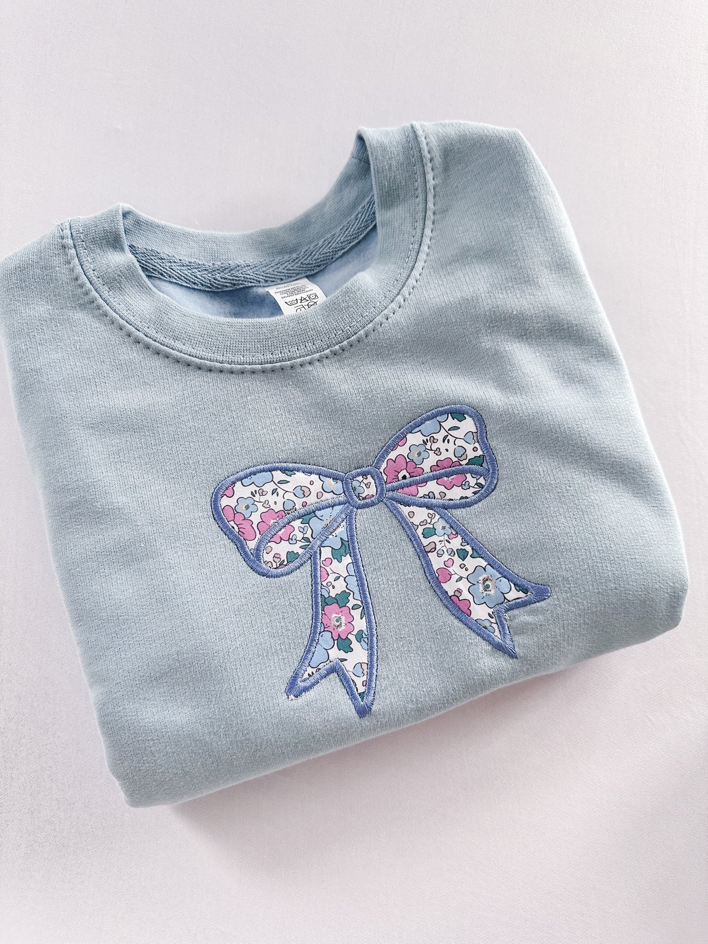 Blue floral bow jumper
