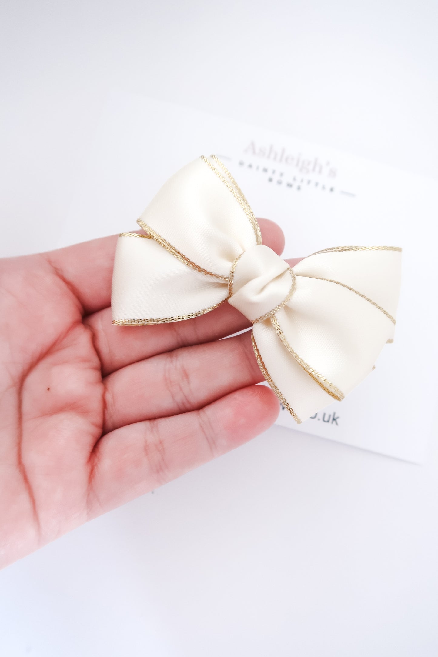 Cream gold edge bow