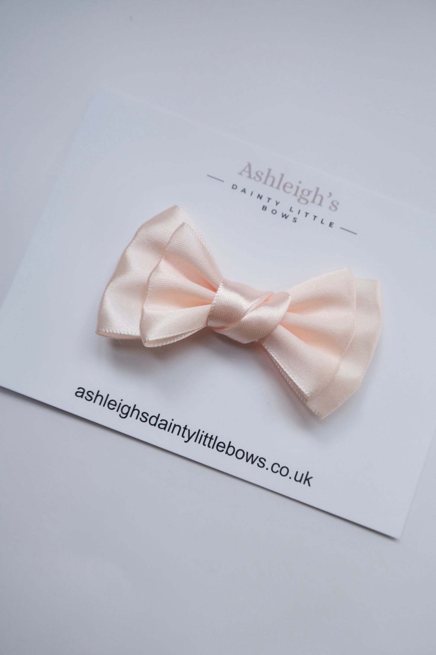 Pretty twist bow in peach