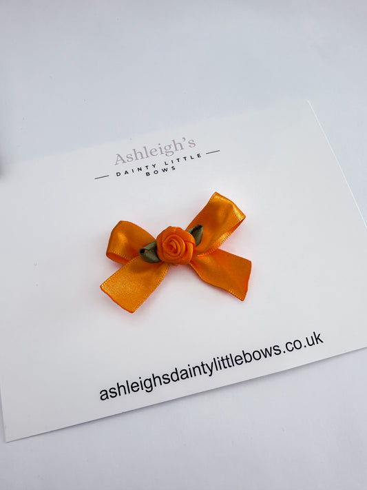 Orange rose bud bow
