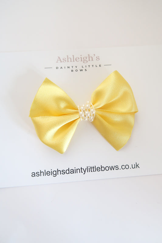 Sunshine yellow pearl centre bow