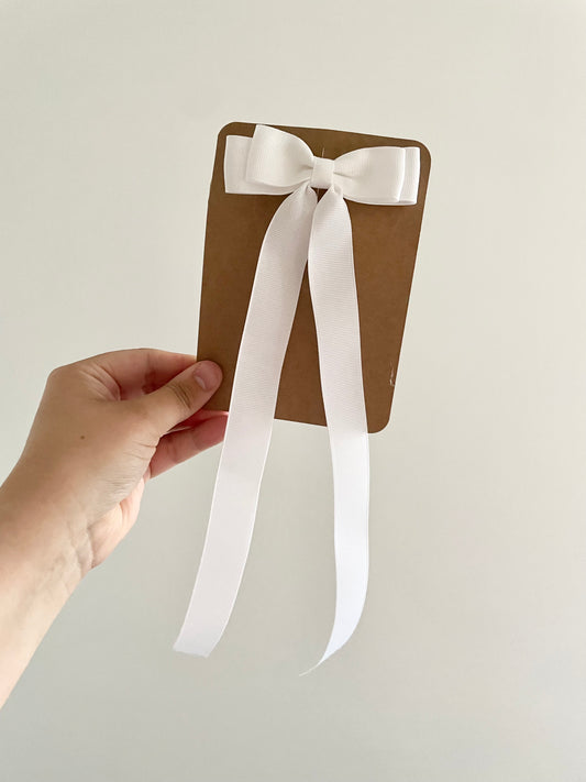 Long tailed white ribbon bow